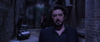 Movie still from “Carlito's Way” (1993), directed by Brian De Palma – A man in a suit and a woman in a black jacket; Medium shot, Over the shoulder angle