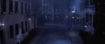 Movie still from “Carlito's Way” (1993), directed by Brian De Palma – A dark city street at night in the rain; Extreme Wide shot, High angle