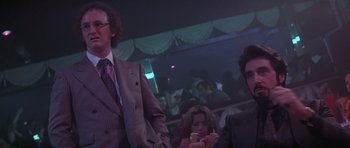Movie still from “Carlito's Way” (1993), directed by Brian De Palma – A man and a woman in a crowd of people; Medium shot, Low angle