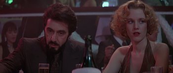 Movie still from “Carlito's Way” (1993), directed by Brian De Palma – A man and a woman sitting at a dinner table; Close Up shot, Over the shoulder angle