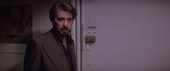 Movie still from “Carlito's Way” (1993), directed by Brian De Palma – A person standing next to a door; Close Up shot, Over the shoulder angle