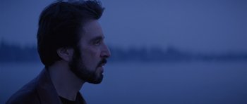 Movie still from “Carlito's Way” (1993), directed by Brian De Palma – A person with a beard looking to the side; Close Up shot, Over the shoulder angle