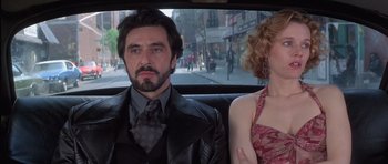 Movie still from “Carlito's Way” (1993), directed by Brian De Palma – A man and a woman sitting in the back of a car; Medium shot, Low angle