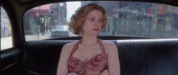 Movie still from “Carlito's Way” (1993), directed by Brian De Palma – A woman sitting in the back seat of a car; Close Up shot, Low angle