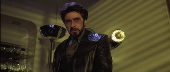 Movie still from “Carlito's Way” (1993), directed by Brian De Palma – A man in a black leather jacket and a tie; Medium shot, Low angle
