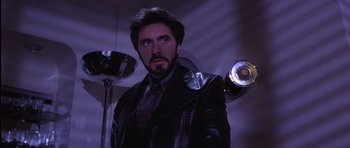 Movie still from “Carlito's Way” (1993), directed by Brian De Palma – A man in a leather jacket standing in front of a lamp; Close Up shot, Low angle