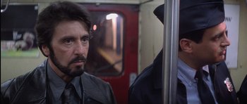 Movie still from “Carlito's Way” (1993), directed by Brian De Palma – A person on a train; Close Up shot, Over the shoulder angle