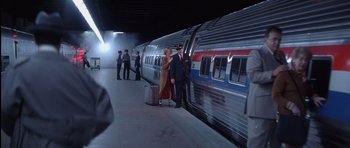 Movie still from “Carlito's Way” (1993), directed by Brian De Palma – A couple of people standing next to a train; Wide shot, High angle