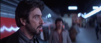 Movie still from “Carlito's Way” (1993), directed by Brian De Palma – A person wearing a suit and tie; Close Up shot, Over the shoulder angle