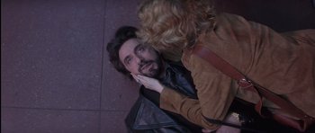 Movie still from “Carlito's Way” (1993), directed by Brian De Palma – A man with a beard is looking at a woman with curly blonde hair; Close Up shot, Overhead angle