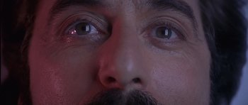 Movie still from “Carlito's Way” (1993), directed by Brian De Palma – A man's eyes and a mustache; Extreme Close Up shot, Overhead angle