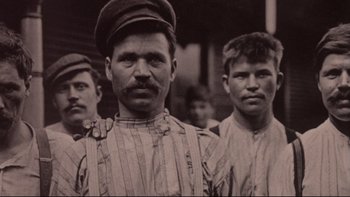 Movie still from “Days of Heaven” (1978), directed by Terrence Malick – A black and white photo of a group of men; Close Up shot, Low angle