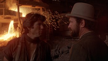 Movie still from “Days of Heaven” (1978), directed by Terrence Malick – A man and a man wearing a hat standing next to each other; Close Up shot, Over the shoulder angle