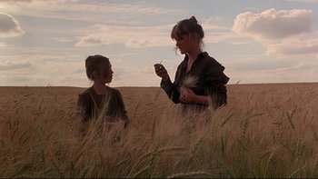 Movie still from “Days of Heaven” (1978), directed by Terrence Malick – A woman and a child in a field of wheat; Wide shot, Low angle