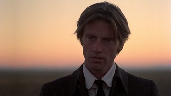 Movie still from “Days of Heaven” (1978), directed by Terrence Malick – A person wearing a suit and tie; Close Up shot, Low angle
