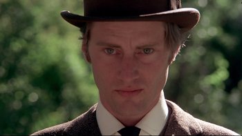 Movie still from “Days of Heaven” (1978), directed by Terrence Malick – A person wearing a suit and hat; Close Up shot, Low angle