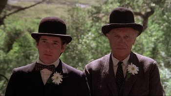 Movie still from “Days of Heaven” (1978), directed by Terrence Malick – Two men in suits and hats are posing for a picture; Close Up shot, Low angle