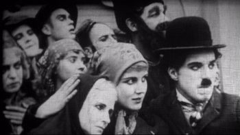 Movie still from “Days of Heaven” (1978), directed by Terrence Malick – A black and white photo of a group of people; Medium shot, High angle