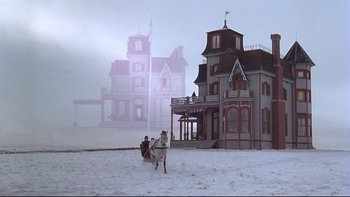Movie still from “Days of Heaven” (1978), directed by Terrence Malick – A man riding a horse drawn carriage in front of a house; Extreme Wide shot, Low angle