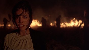 Movie still from “Days of Heaven” (1978), directed by Terrence Malick – A woman standing in front of a burning field; Close Up shot, Low angle