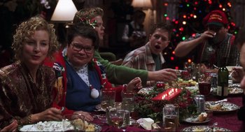 Movie still from “Cast Away” (2000), directed by Robert Zemeckis – A group of people sitting around a table with a lit candle; Medium shot, Over the shoulder angle