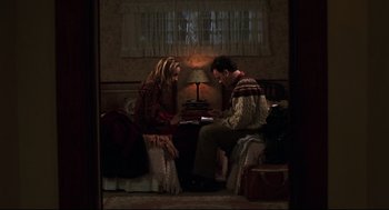 Movie still from “Cast Away” (2000), directed by Robert Zemeckis – A man and a woman sitting in front of each other; Medium shot, Overhead angle