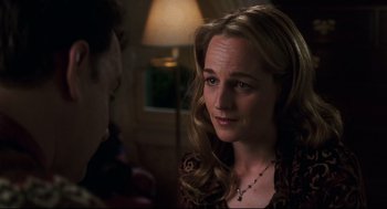 Movie still from “Cast Away” (2000), directed by Robert Zemeckis – A woman with long blonde hair wearing a leopard print shirt; Close Up shot, Over the shoulder angle