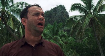 Movie still from “Cast Away” (2000), directed by Robert Zemeckis – A man in a red shirt is crying in the jungle; Close Up shot, Low angle