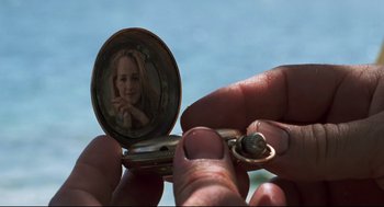 Movie still from “Cast Away” (2000), directed by Robert Zemeckis – A person holding a picture in a pocket watch; Extreme Close Up shot, High angle