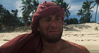 Movie still from “Cast Away” (2000), directed by Robert Zemeckis – A person wearing a turban on the beach; Close Up shot, Low angle