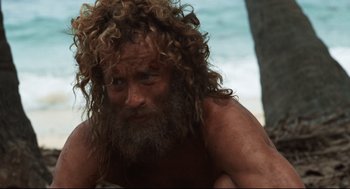 Movie still from “Cast Away” (2000), directed by Robert Zemeckis – A person with long hair and a beard; Close Up shot, High angle