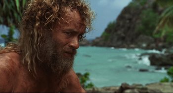 Movie still from “Cast Away” (2000), directed by Robert Zemeckis – A person with long hair and a beard; Close Up shot, Low angle