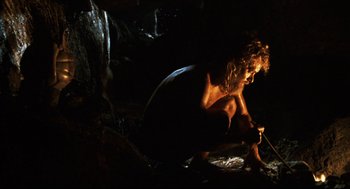 Movie still from “Cast Away” (2000), directed by Robert Zemeckis – A woman sitting on the ground in the dark; Wide shot, Low angle