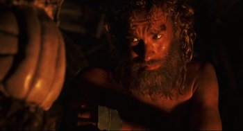 Movie still from “Cast Away” (2000), directed by Robert Zemeckis – A man with long hair and a big beard; Close Up shot, Over the shoulder angle