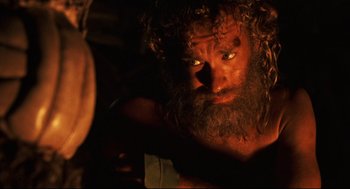 Movie still from “Cast Away” (2000), directed by Robert Zemeckis – A man with a long beard is looking at the camera; Close Up shot, Low angle