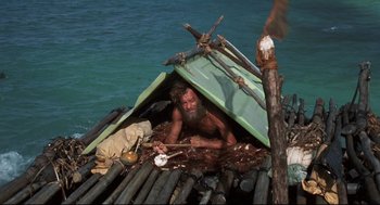 Movie still from “Cast Away” (2000), directed by Robert Zemeckis – A man sitting on a raft in the water; Wide shot, High angle