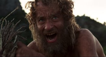 Movie still from “Cast Away” (2000), directed by Robert Zemeckis – A person with long hair and a beard; Close Up shot, Low angle