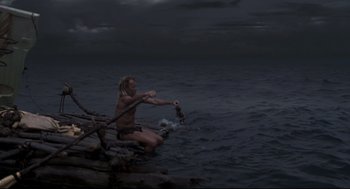 Movie still from “Cast Away” (2000), directed by Robert Zemeckis – A man in the water holding onto a rope; Wide shot, High angle