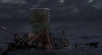 Movie still from “Cast Away” (2000), directed by Robert Zemeckis – A man sitting on a raft in the middle of the ocean; Wide shot, High angle