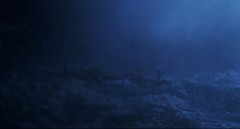 Movie still from “Cast Away” (2000), directed by Robert Zemeckis – Two people standing in the ocean in the dark; Extreme Wide shot, High angle