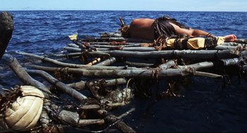 Movie still from “Cast Away” (2000), directed by Robert Zemeckis – A man on a raft in the water; Wide shot, High angle