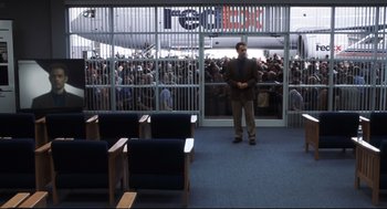Movie still from “Cast Away” (2000), directed by Robert Zemeckis – A man standing in front of a crowd of people; Extreme Wide shot, High angle