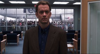 Movie still from “Cast Away” (2000), directed by Robert Zemeckis – A man in a brown jacket and a blue shirt; Medium shot, Low angle