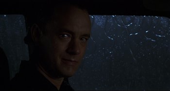 Movie still from “Cast Away” (2000), directed by Robert Zemeckis – A person in a dark room; Close Up shot, Over the shoulder angle