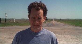 Movie still from “Cast Away” (2000), directed by Robert Zemeckis – A man standing on the side of a road; Close Up shot, Low angle