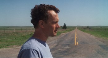 Movie still from “Cast Away” (2000), directed by Robert Zemeckis – A man standing on the side of a road; Close Up shot, Over the shoulder angle