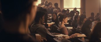 Movie still from “Cherry” (2021), directed by Joe Russo – A group of people sitting in a room reading books; Wide shot, Over the shoulder angle