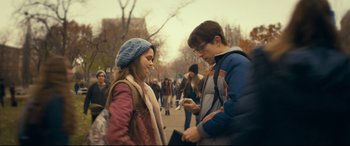 Movie still from “Cherry” (2021), directed by Joe Russo – A man and a woman looking at a cell phone; Medium shot, Over the shoulder angle