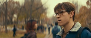 Movie still from “Cherry” (2021), directed by Joe Russo – A man with glasses is looking at the camera; Close Up shot, Over the shoulder angle