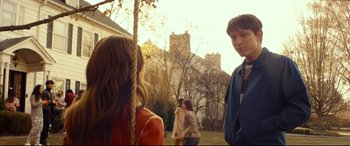 Movie still from “Cherry” (2021), directed by Joe Russo – Two young people standing in a yard next to each other; Medium shot, Over the shoulder angle